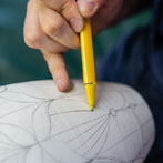 Rhian Malin decorating a mandala bottle in her workshop 2019
